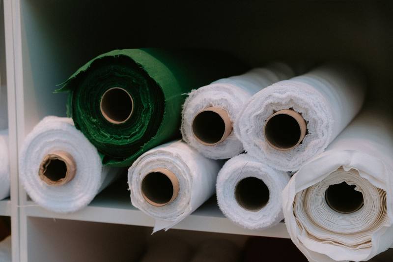 Rolls of fabric stacked on shelves